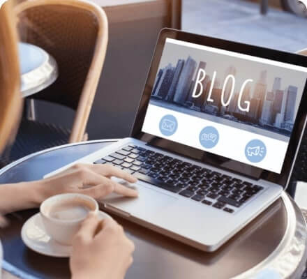 Person typing on a laptop with 'BLOG' on screen